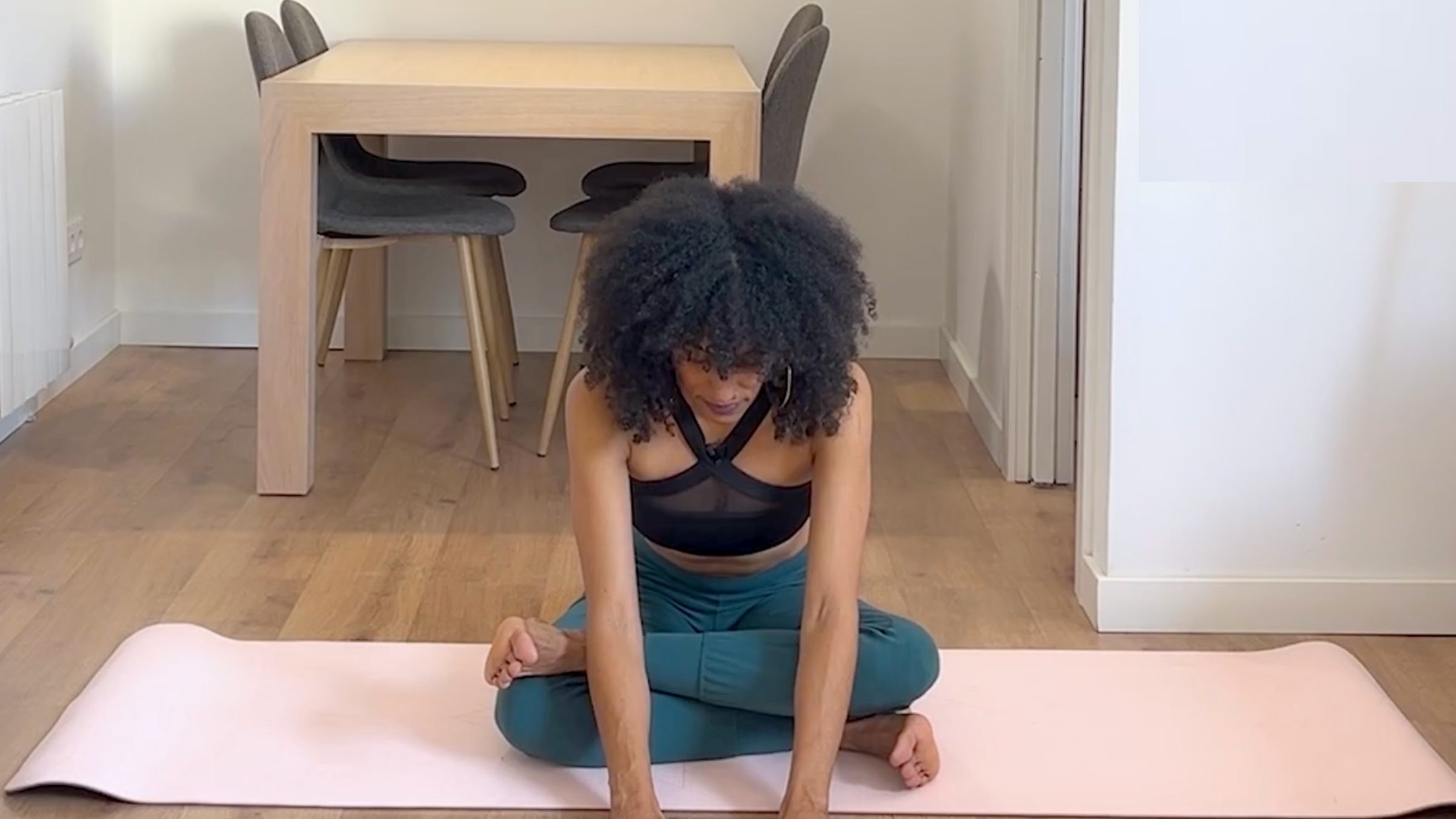 Yoga teacher practicing Firelog pose.